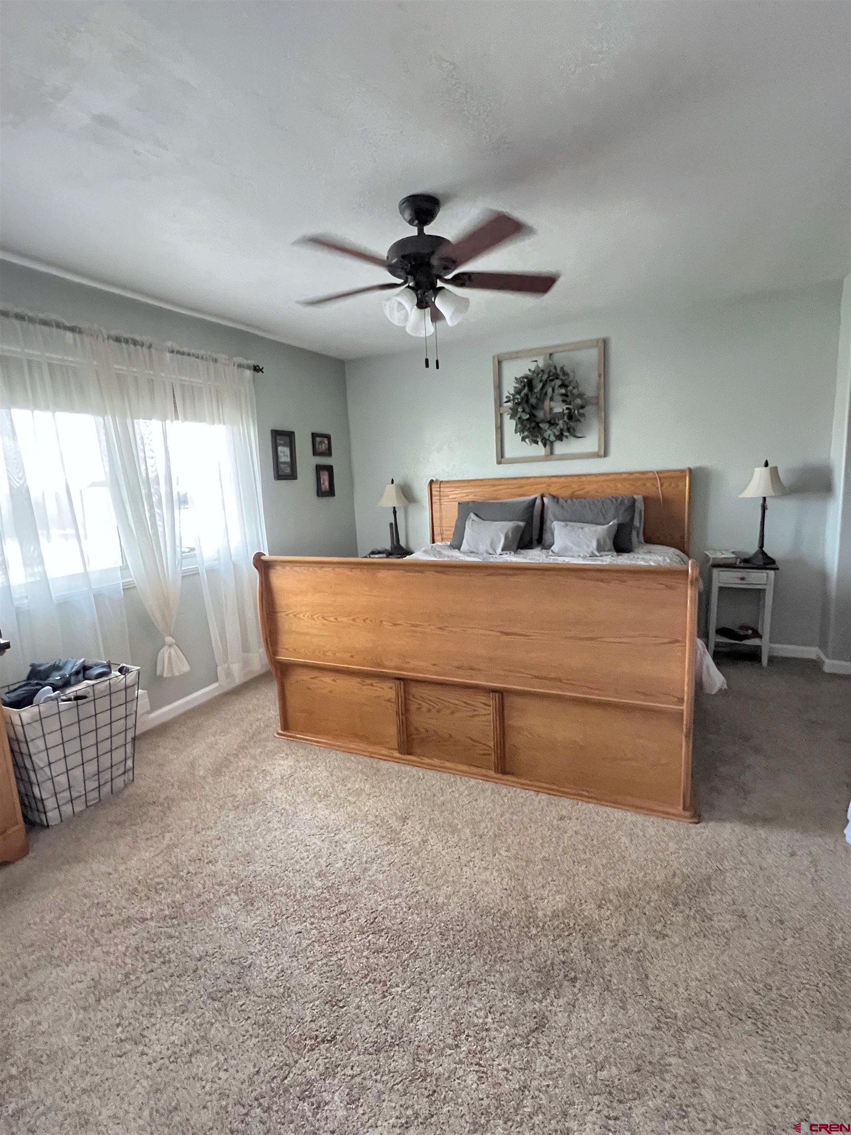 7571 2200th Road Delta, CO 81416 - Photo 18 of 35 a bedroom with furniture and window