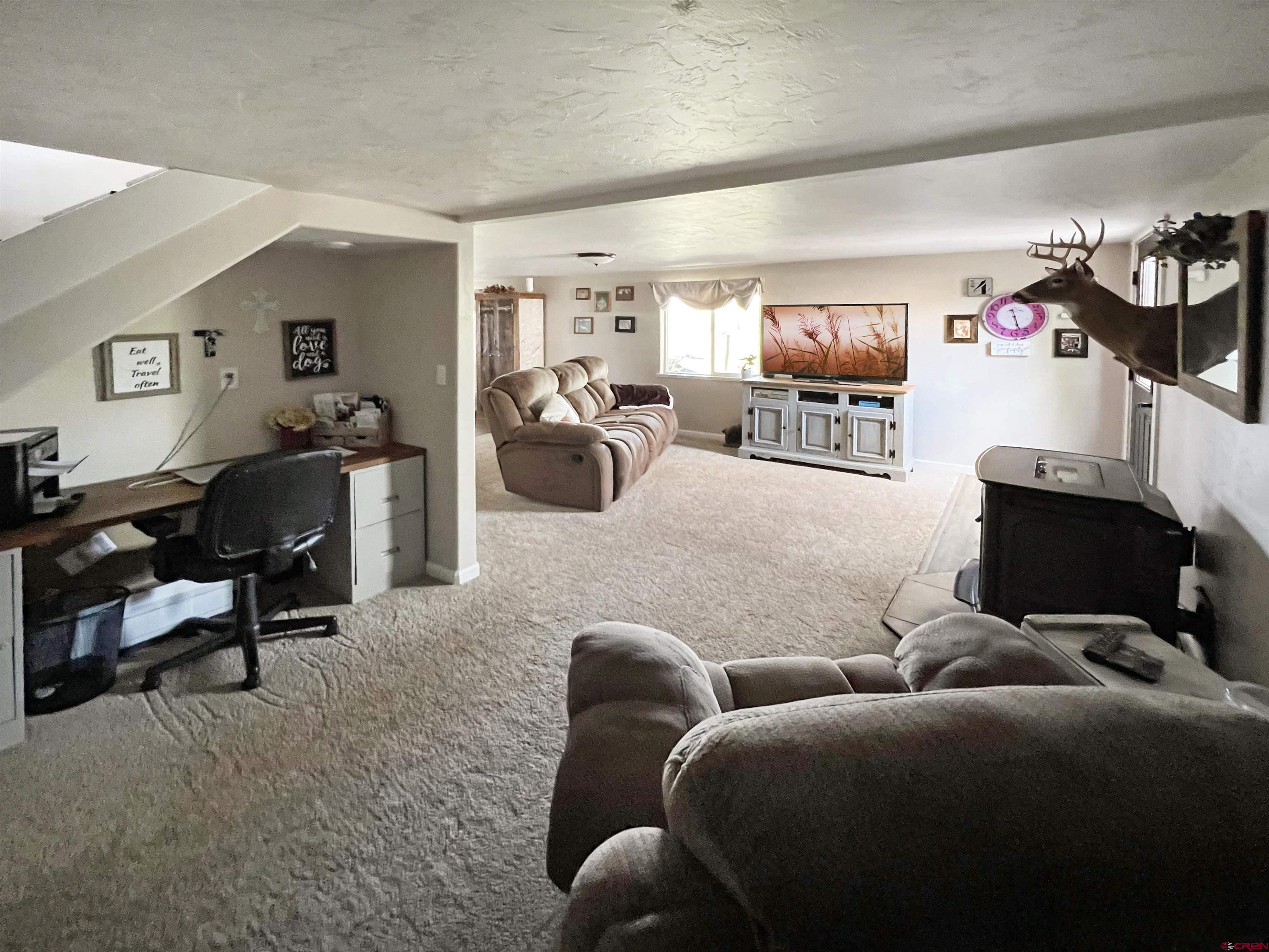 7571 2200th Road Delta, CO 81416 - Photo 20 of 35 a living room with furniture a view of bedroom and a window