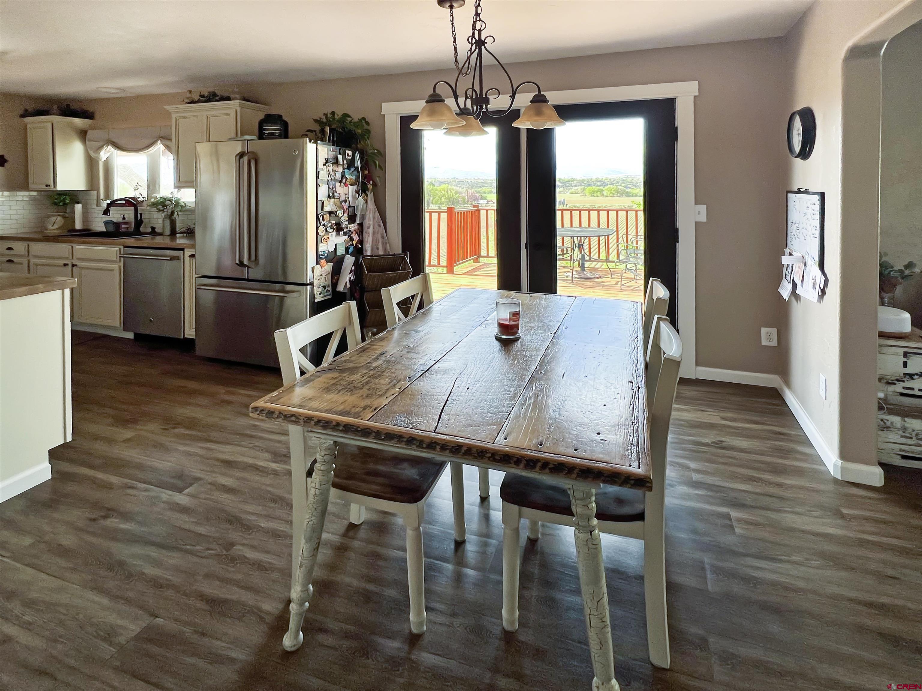 7571 2200th Road Delta, CO 81416 - Photo 9 of 35 a view of a dining room with furniture window and wooden floor