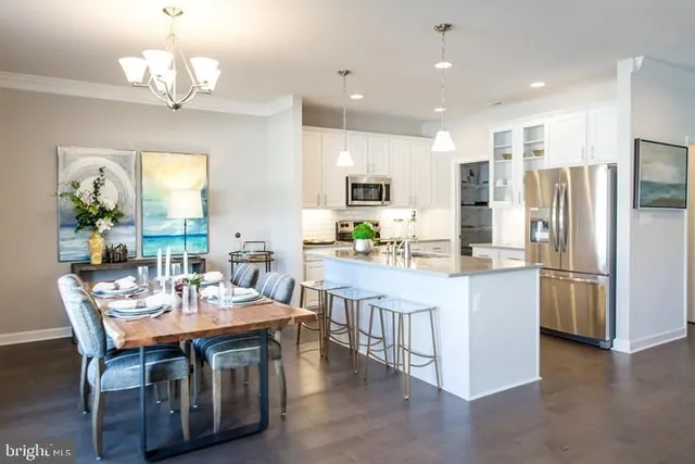 a kitchen with kitchen island granite countertop a center island a sink stainless steel appliances and cabinets