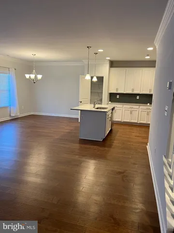 a view of kitchen with kitchen island microwave and stove
