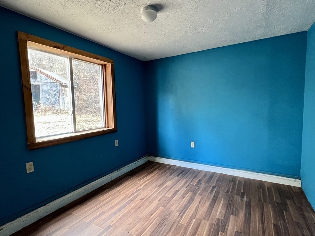 100 Main Road Colrain, MA 01340 - Photo 8 of 10 a view of empty room with wooden floor and fan