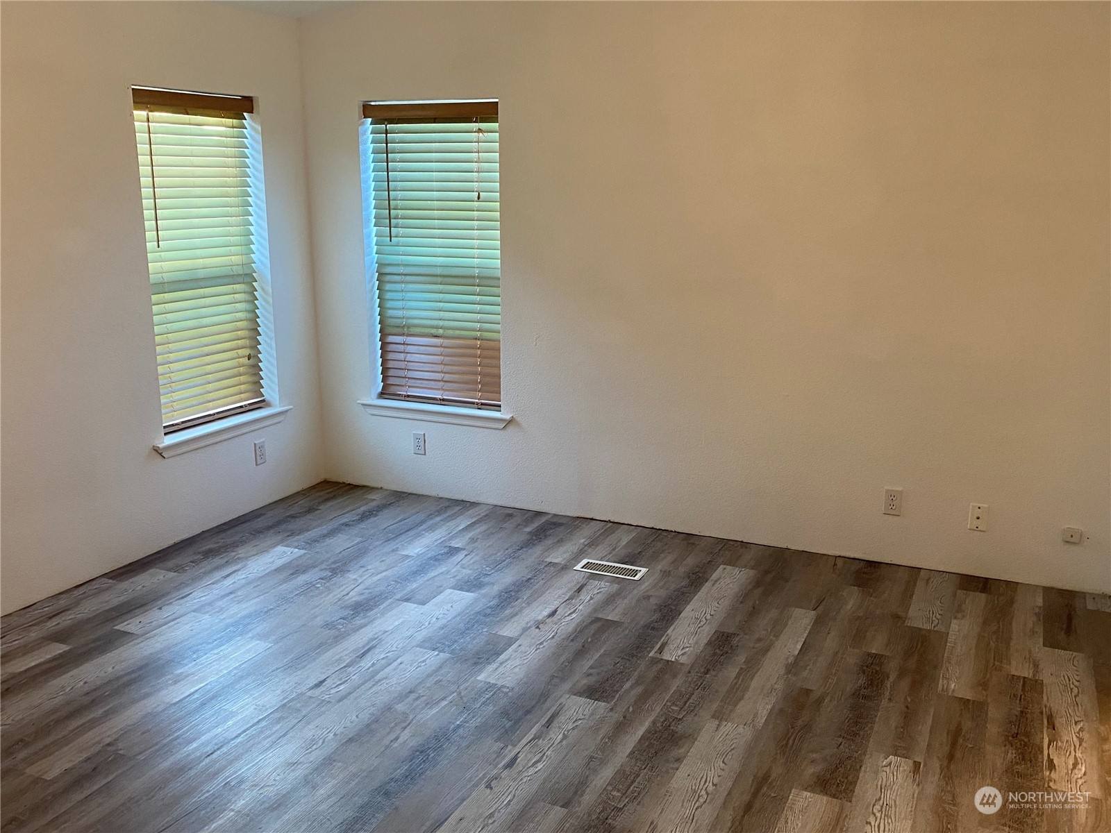 19220 Old Ranch Lane Southwest Rochester, WA 98579 - Photo 12 of 19 an empty room with wooden floor and a window