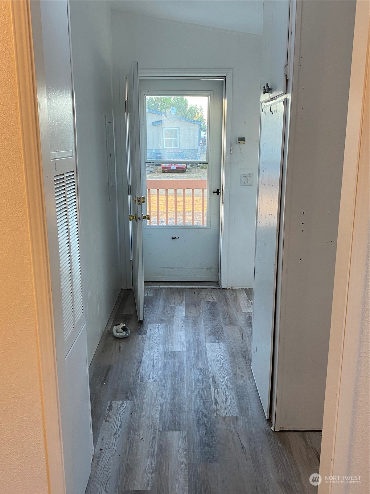19220 Old Ranch Lane Southwest Rochester, WA 98579 - Photo 14 of 19 an empty room with wooden floor and windows