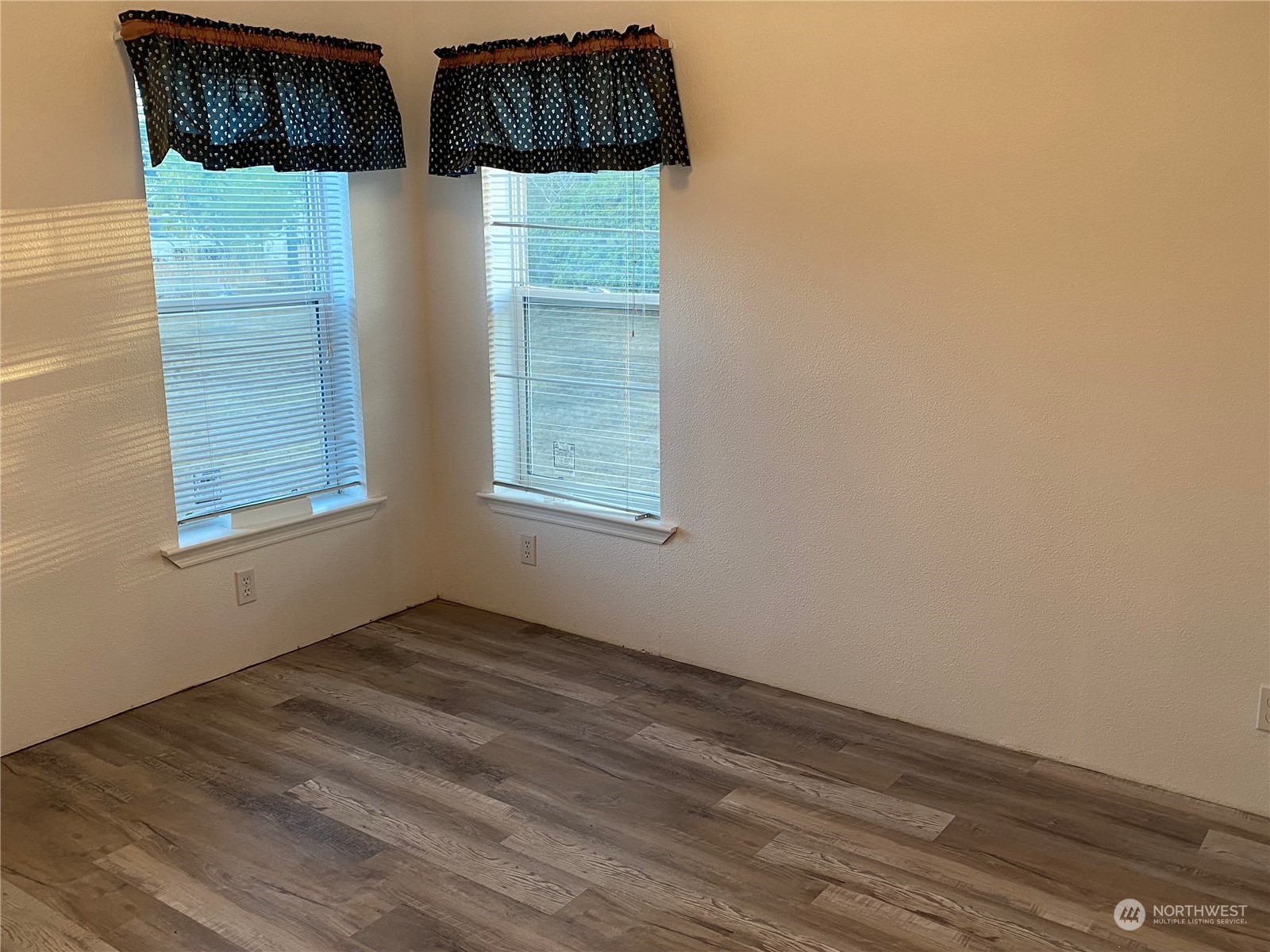 19220 Old Ranch Lane Southwest Rochester, WA 98579 - Photo 15 of 19 an empty room with wooden floor and windows