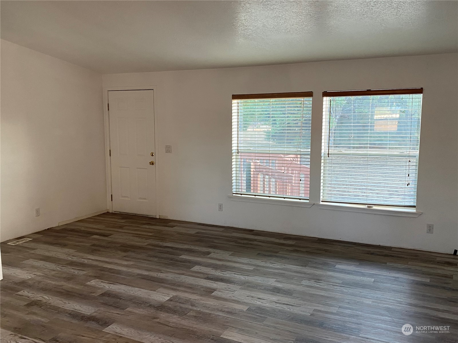 19220 Old Ranch Lane Southwest Rochester, WA 98579 - Photo 16 of 19 a view of an empty room with wooden floor and a window