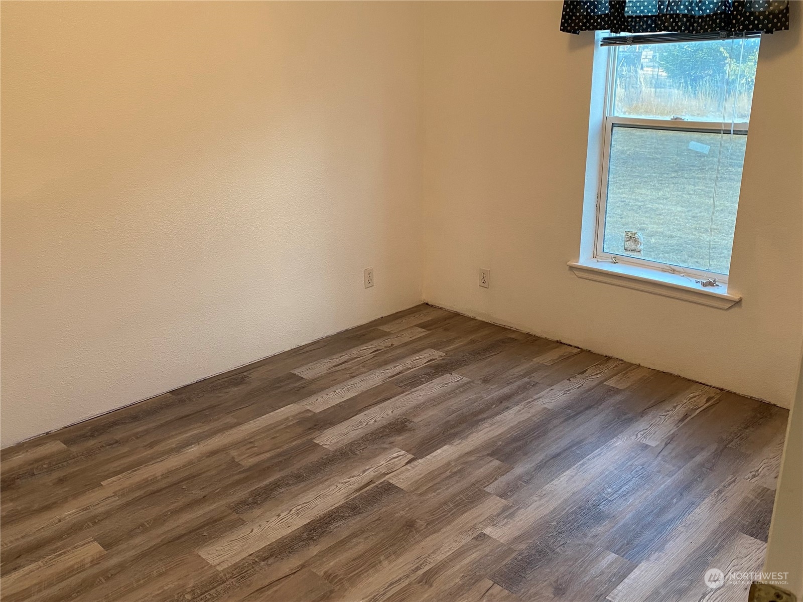 19220 Old Ranch Lane Southwest Rochester, WA 98579 - Photo 19 of 19 a view of a room with wooden floor and a window
