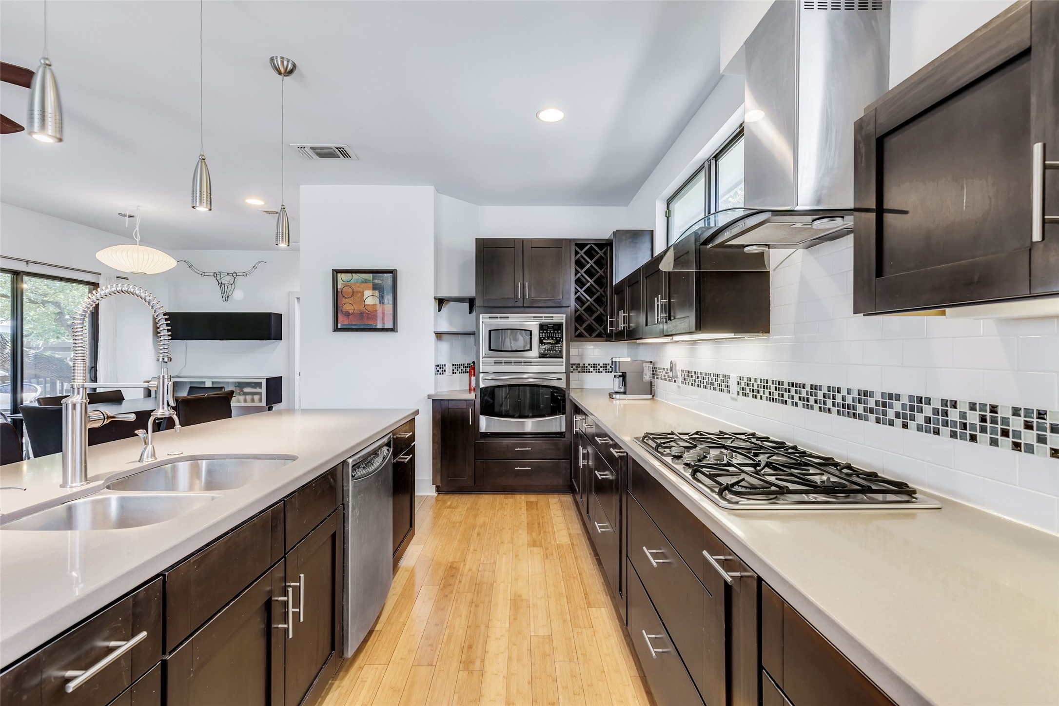 815 Columbus Street Austin, TX 78704 - Photo 7 of 39 a kitchen with stainless steel appliances a sink a stove top oven a counter space and cabinets