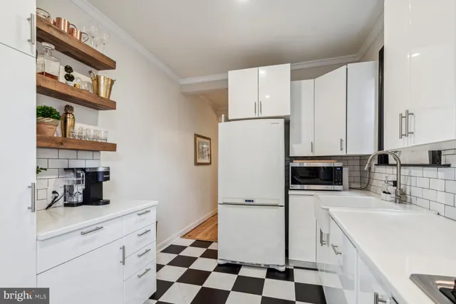 a kitchen with a refrigerator a stove a sink and cabinets