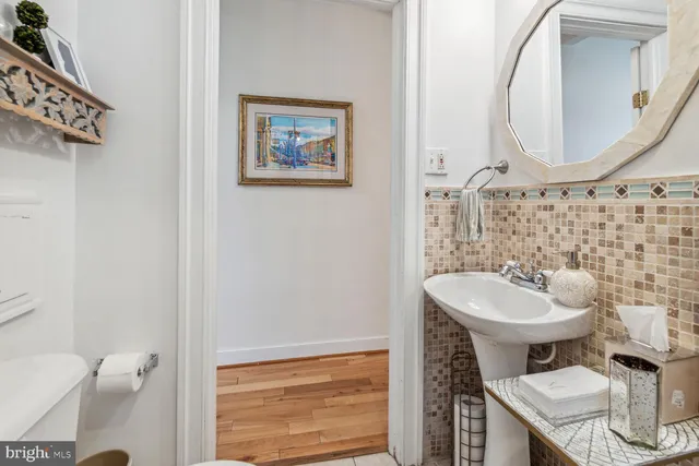 a bathroom with a toilet sink and mirror