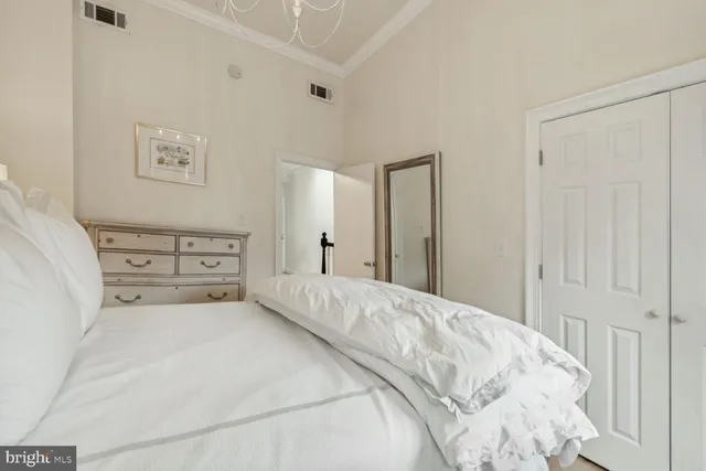 a spacious bedroom with a bed and a cabinets