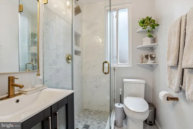 a bathroom with a sink toilet and shower