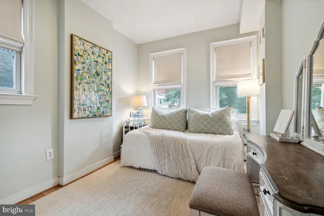 a bedroom with a bed and a couch