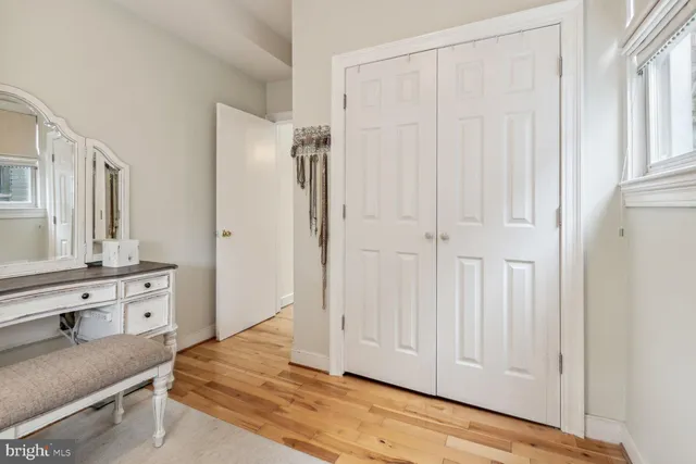 a view of a bedroom with wooden floor and cabinet
