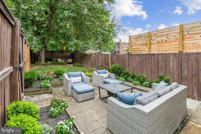 a view of a patio with couches chairs and a fire pit