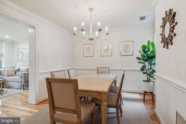 a view of a dining room with furniture and chandelier