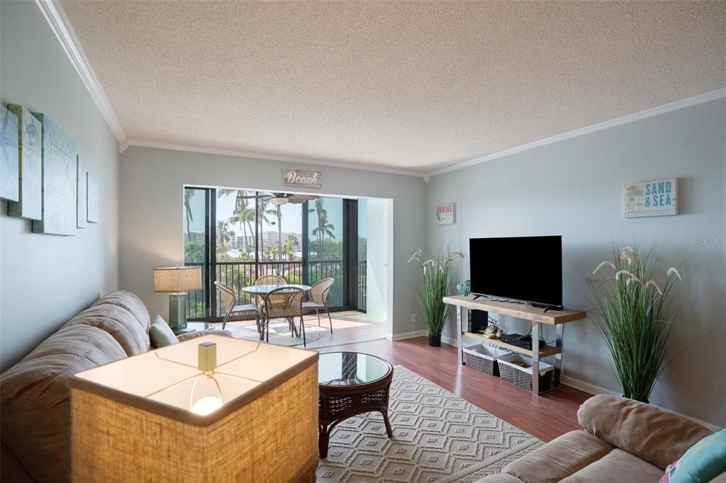5855 Midnight Pass Road, Unit 327 Sarasota, FL 34242 - Photo 11 of 47 a living room with furniture and a flat screen tv