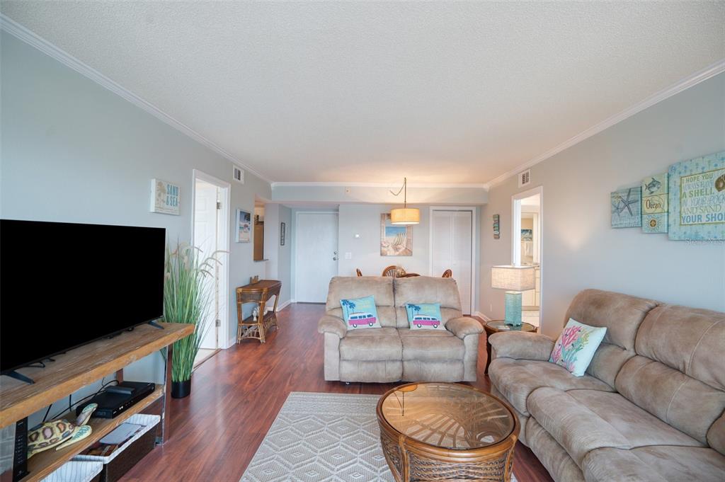 5855 Midnight Pass Road, Unit 327 Sarasota, FL 34242 - Photo 12 of 47 a living room with furniture and a flat screen tv