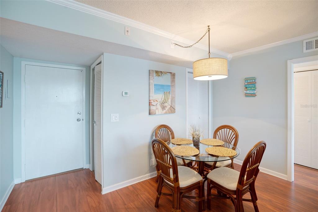 5855 Midnight Pass Road, Unit 327 Sarasota, FL 34242 - Photo 13 of 47 a view of a dining room with furniture wooden floor and chandelier