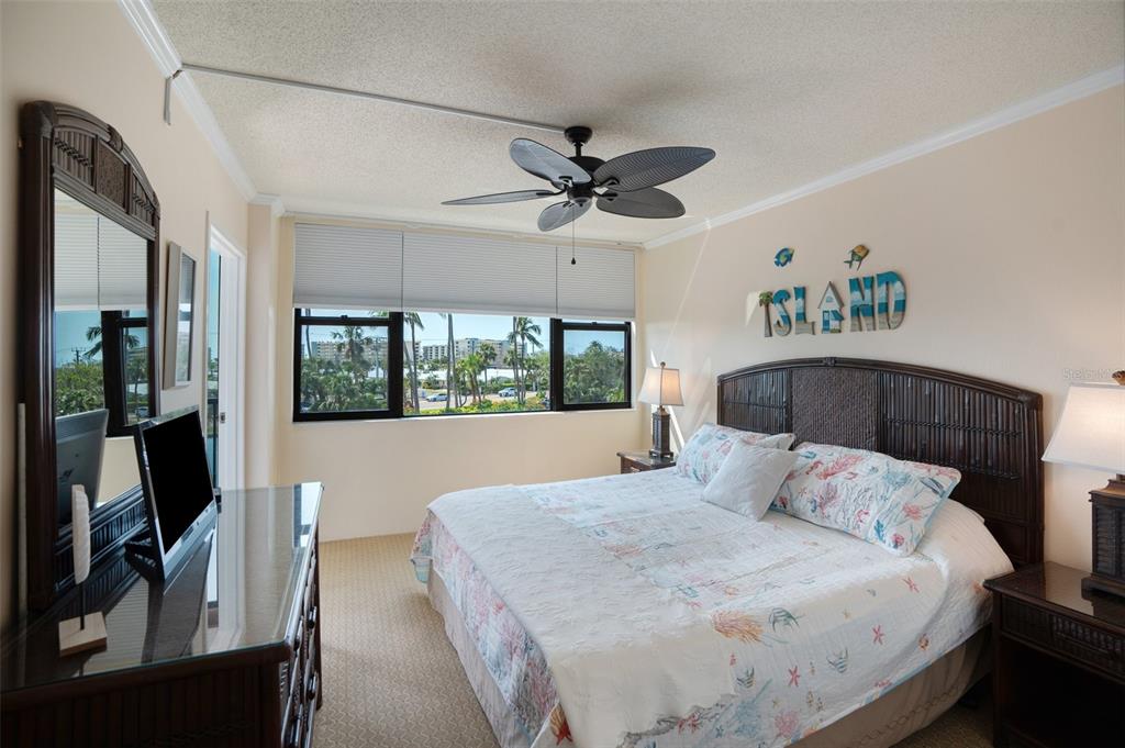 5855 Midnight Pass Road, Unit 327 Sarasota, FL 34242 - Photo 19 of 47 a bedroom with a bed and a chandelier