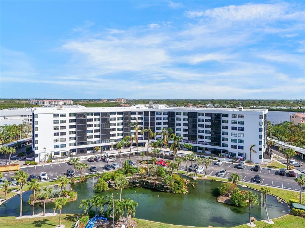 5855 Midnight Pass Road, Unit 327 Sarasota, FL 34242 - Photo 26 of 47 a view of swimming pool and lake view