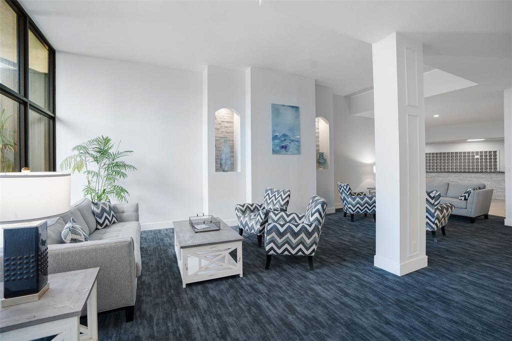 5855 Midnight Pass Road, Unit 327 Sarasota, FL 34242 - Photo 28 of 47 a living room with furniture and wooden floor