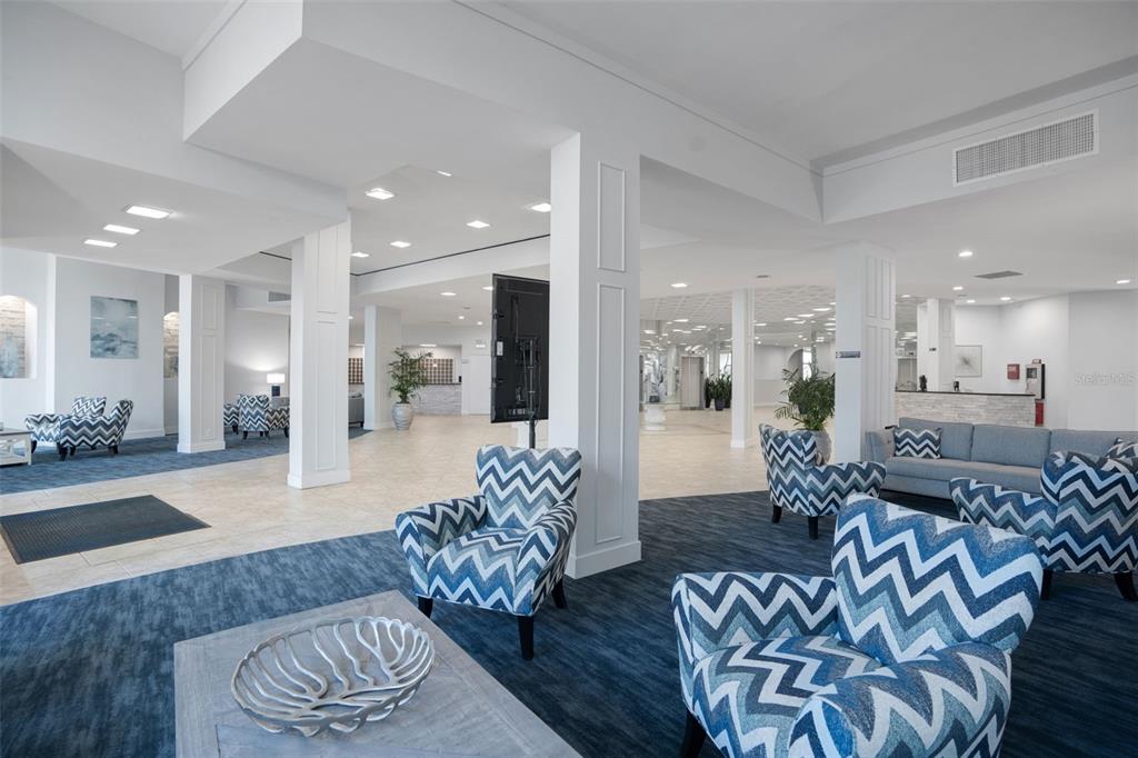 5855 Midnight Pass Road, Unit 327 Sarasota, FL 34242 - Photo 29 of 47 a living room with furniture and a wooden floor