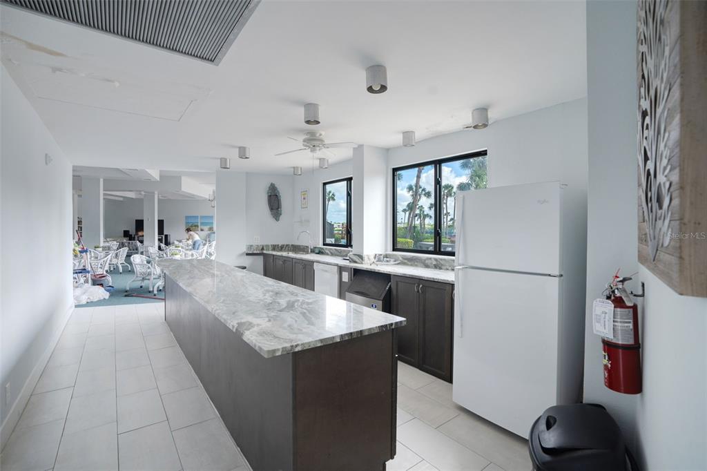 5855 Midnight Pass Road, Unit 327 Sarasota, FL 34242 - Photo 30 of 47 a living room with stainless steel appliances kitchen island granite countertop furniture and a refrigerator