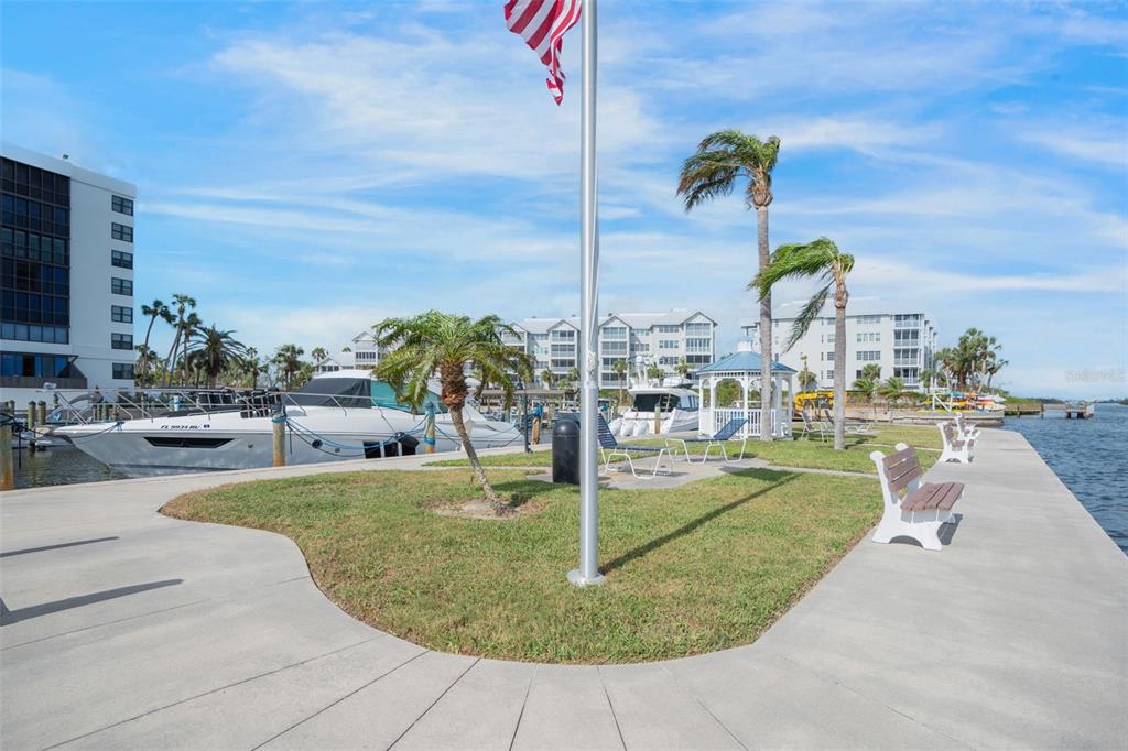 5855 Midnight Pass Road, Unit 327 Sarasota, FL 34242 - Photo 35 of 47 a view of a swimming pool with a lawn chairs
