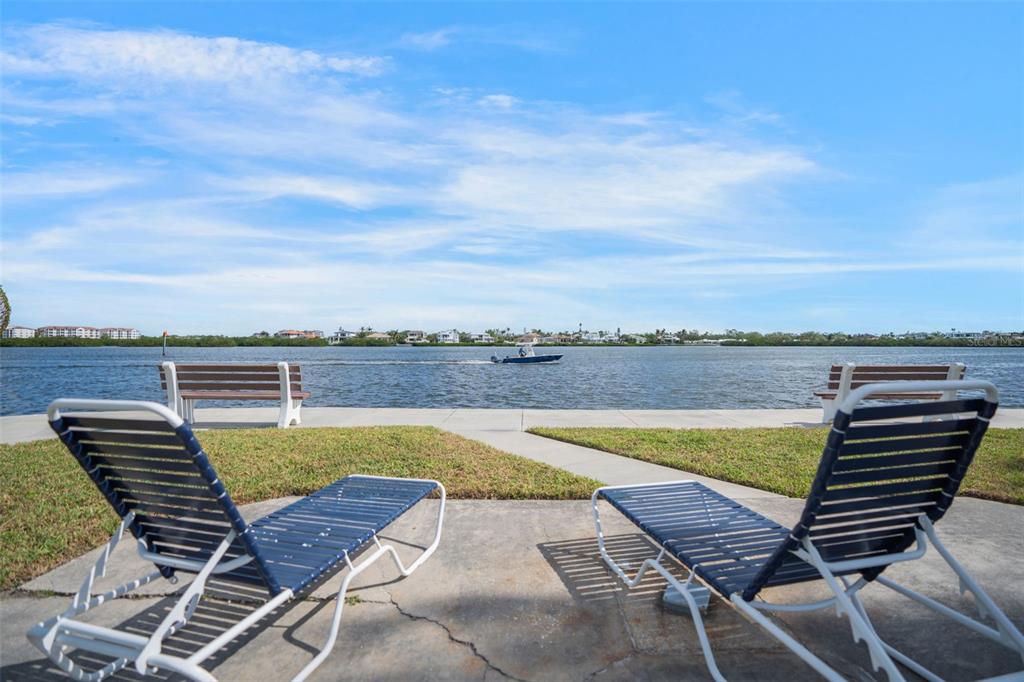 5855 Midnight Pass Road, Unit 327 Sarasota, FL 34242 - Photo 37 of 47 an outdoor sitting area with swimming pool and mountain