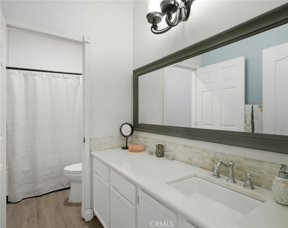 1853 Rue Chablis San Jacinto, CA 92583 - Photo 13 of 27 a bathroom with a sink and a mirror
