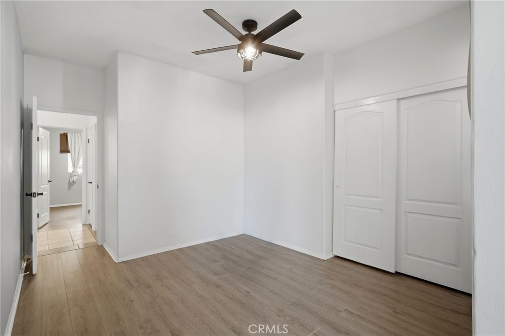 1853 Rue Chablis San Jacinto, CA 92583 - Photo 14 of 27 an empty room with wooden floor and a ceiling fan