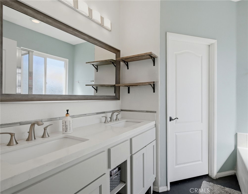 1853 Rue Chablis San Jacinto, CA 92583 - Photo 19 of 27 a bathroom with a sink and a mirror