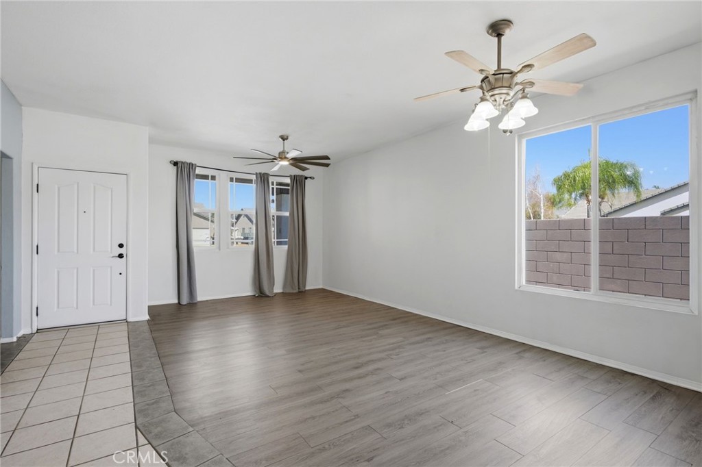 1853 Rue Chablis San Jacinto, CA 92583 - Photo 4 of 27 a view of a livingroom with a chandelier fan and windows