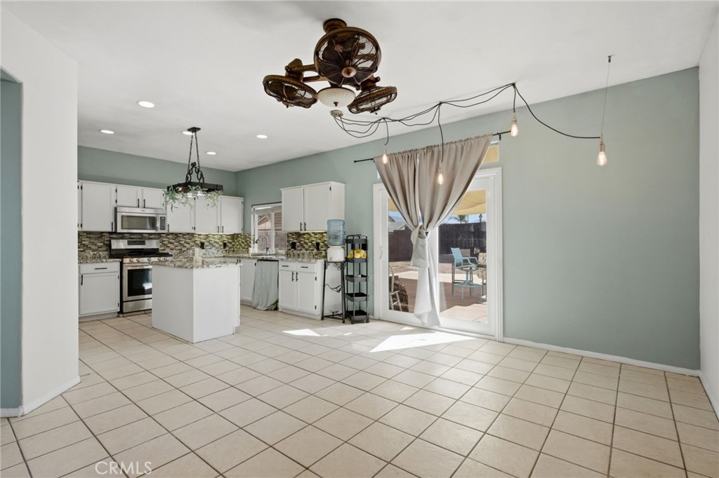 1853 Rue Chablis San Jacinto, CA 92583 - Photo 8 of 27 a kitchen with white cabinets and appliances