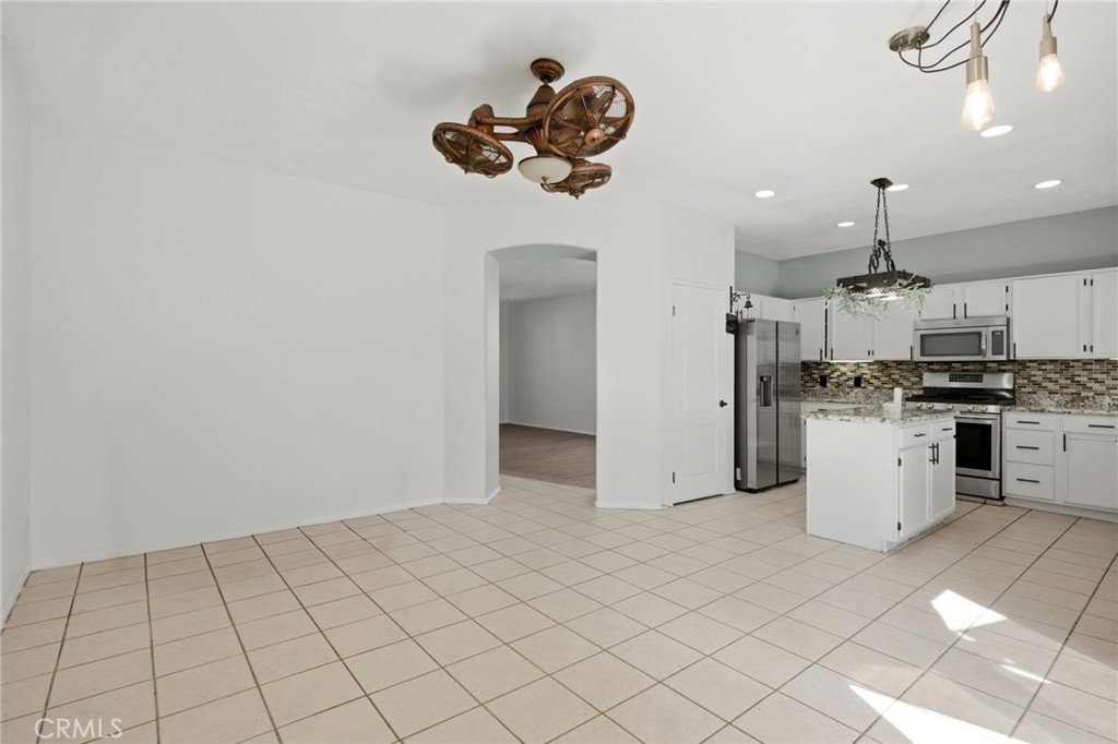 1853 Rue Chablis San Jacinto, CA 92583 - Photo 9 of 27 a kitchen with a refrigerator and white cabinets