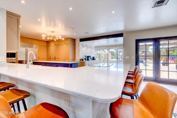 a bedroom with a bed a dresser and book shelf