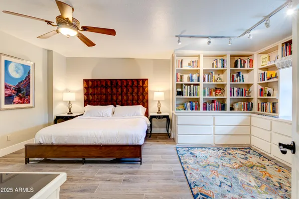 a bedroom with a bed and a chandelier
