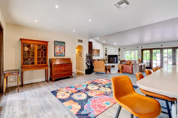 a view of a patio with a table and chairs under an umbrella