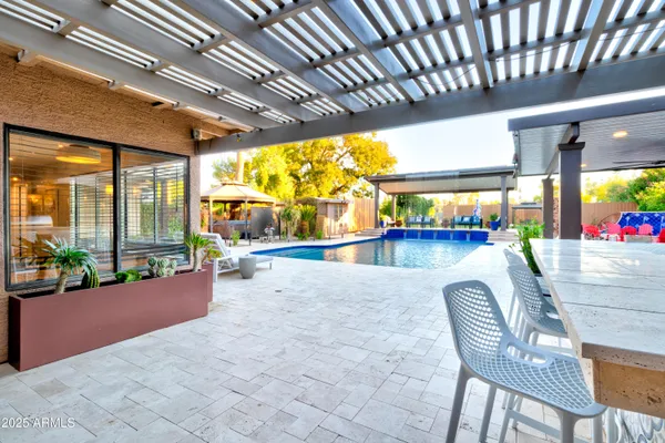 a view of a swimming pool with an outdoor seating