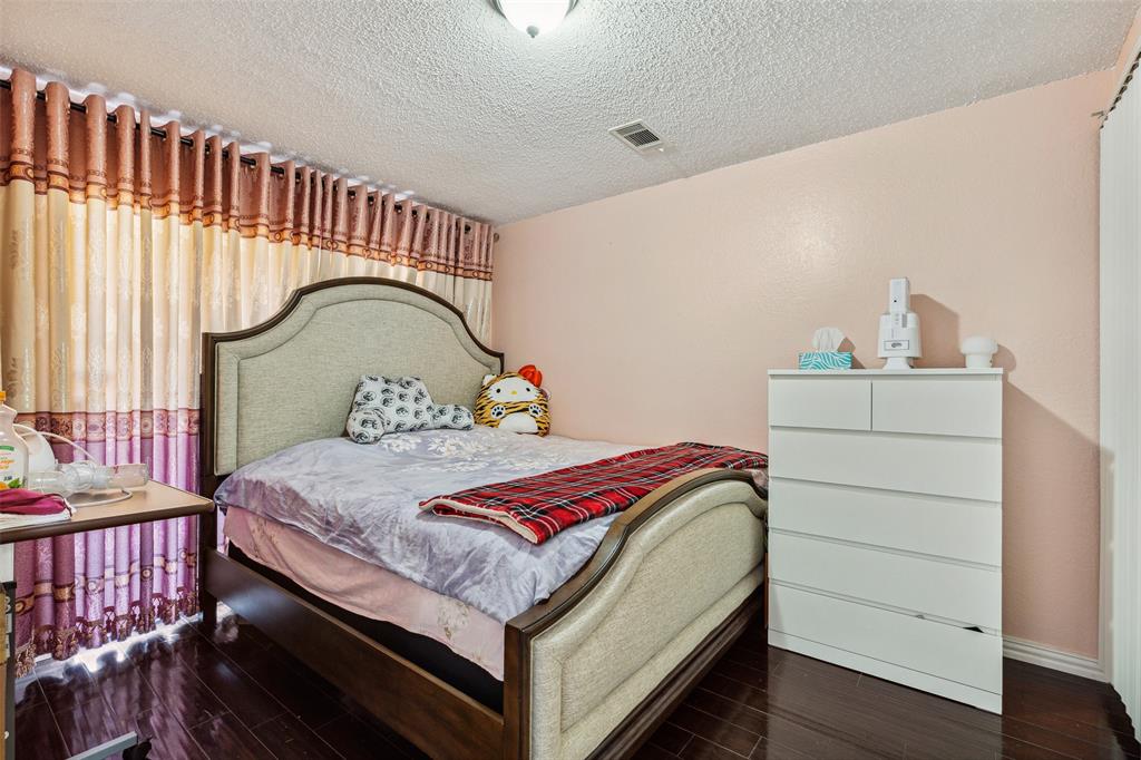 4748 Old Bent Tree Lane, Unit 1901 Dallas, TX 75287 - Photo 11 of 26 a bedroom with a bed and a dresser