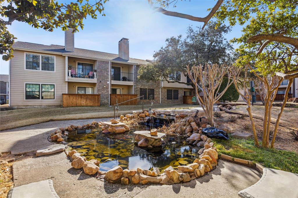 4748 Old Bent Tree Lane, Unit 1901 Dallas, TX 75287 - Photo 16 of 26 a front view of a house with a yard and garage