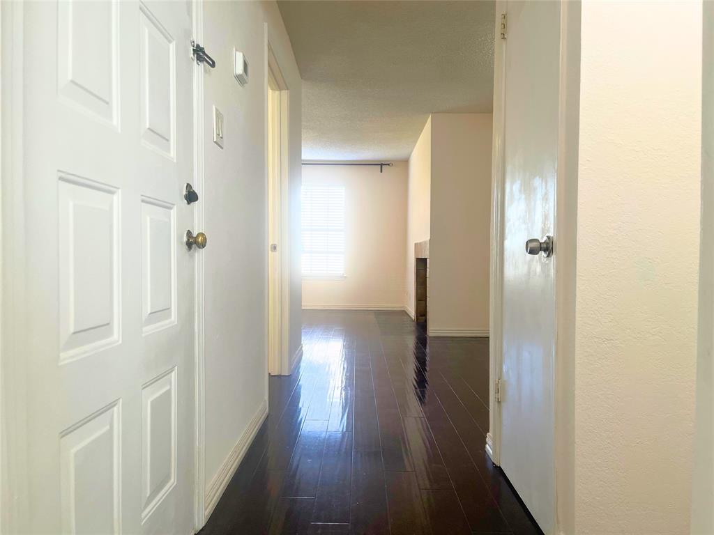 4748 Old Bent Tree Lane, Unit 1901 Dallas, TX 75287 - Photo 19 of 26 a view of a hallway with wooden floor
