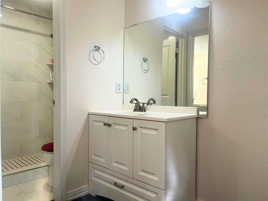 4748 Old Bent Tree Lane, Unit 1901 Dallas, TX 75287 - Photo 24 of 26 a bathroom with a sink mirror vanity and toilet