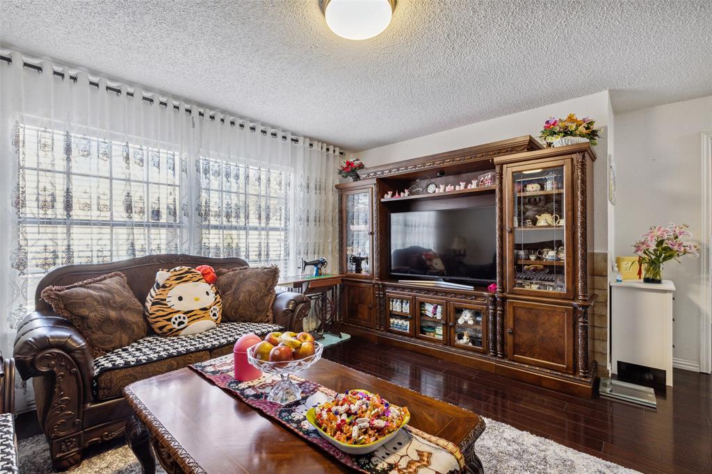 4748 Old Bent Tree Lane, Unit 1901 Dallas, TX 75287 - Photo 6 of 26 a living room with furniture and a flat screen tv