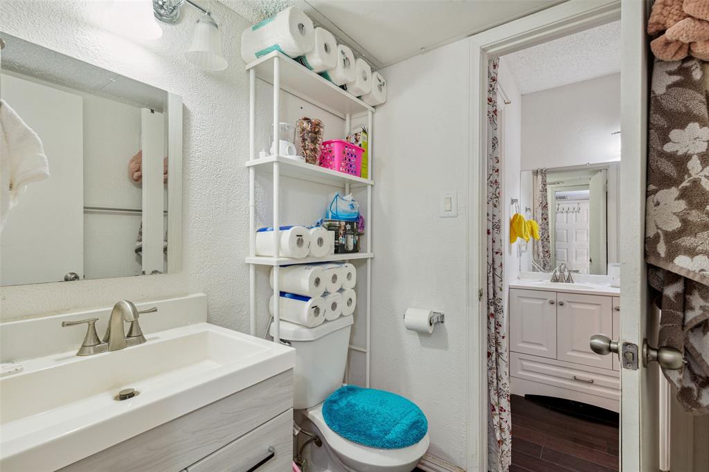4748 Old Bent Tree Lane, Unit 1901 Dallas, TX 75287 - Photo 8 of 26 a bathroom with a sink a toilet and a shower curtain