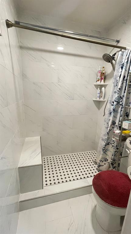 4748 Old Bent Tree Lane, Unit 1901 Dallas, TX 75287 - Photo 10 of 26 a bathroom with a shower and a toilet