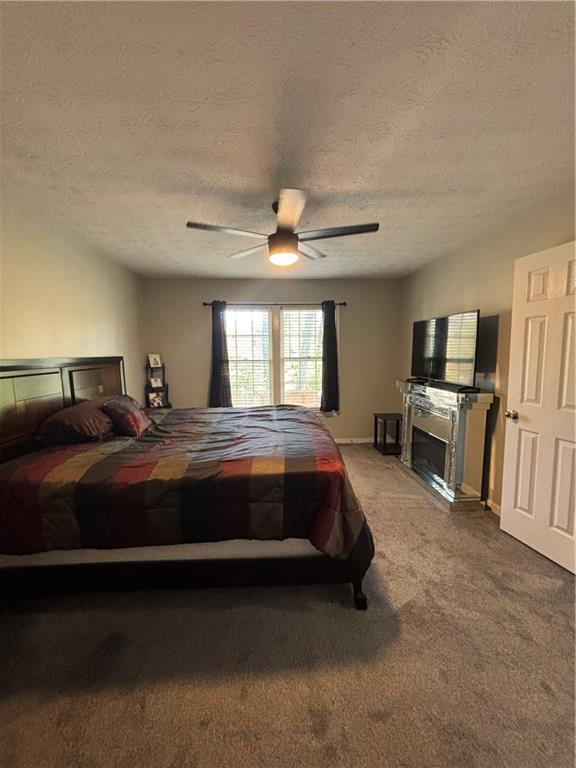 4949 Penscot Way Stone Mountain, GA 30088 - Photo 28 of 40 a spacious bedroom with a bed and a television