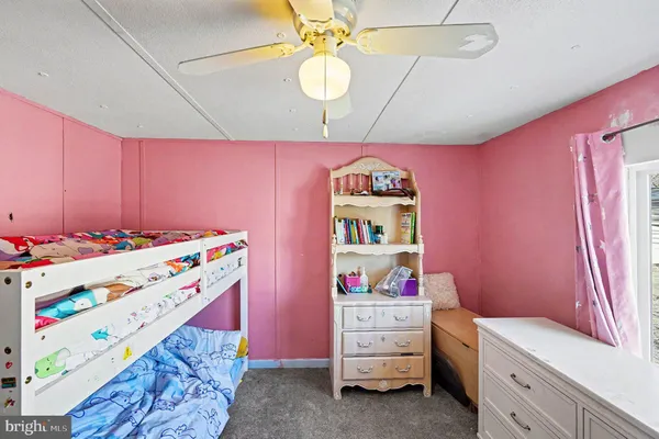 a kids room with toys and dresser