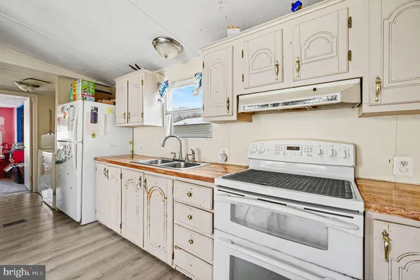 a kitchen with stainless steel appliances granite countertop a sink and cabinets